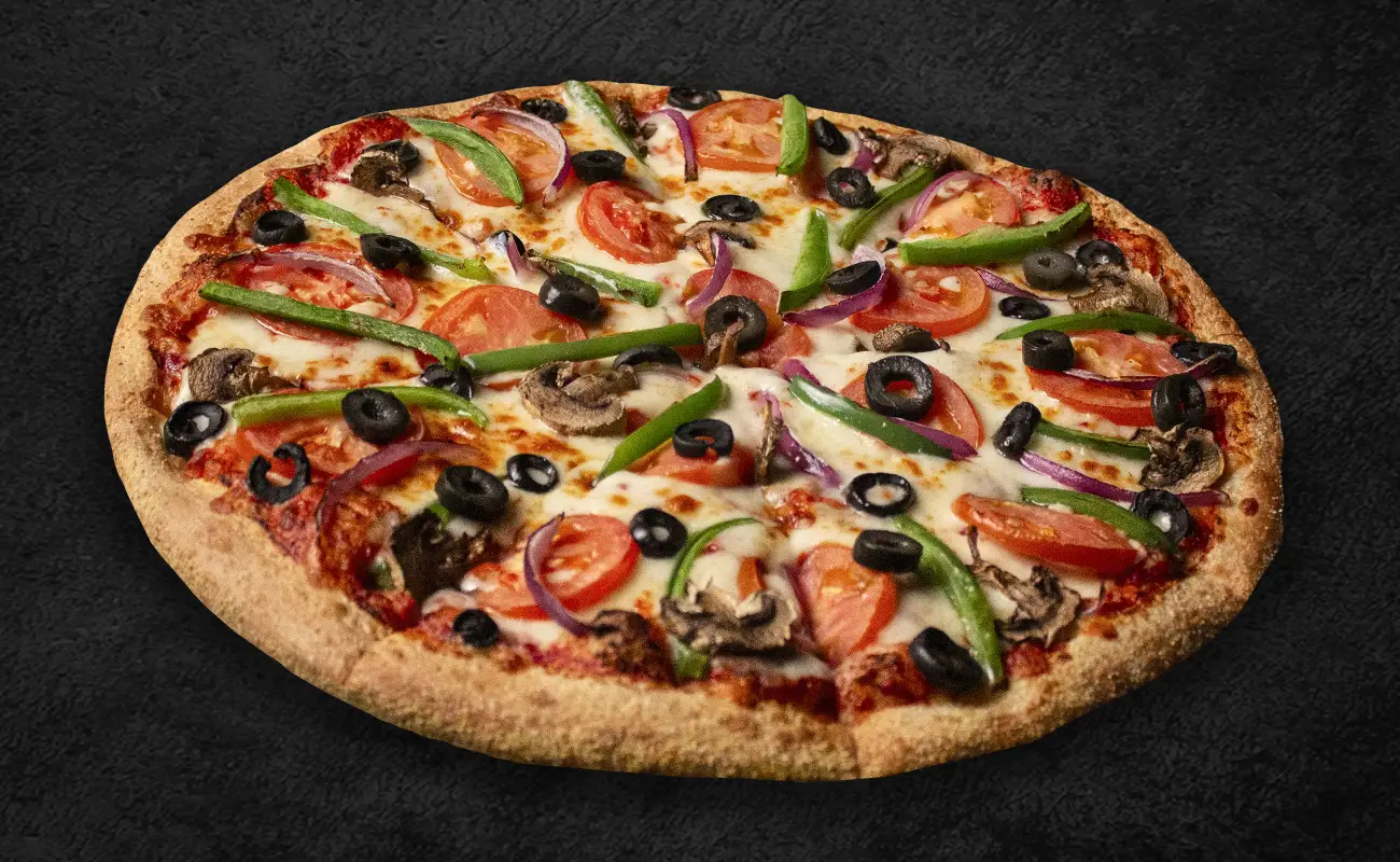 Freshly baked veggie pizza topped with tomatoes, green bell peppers, black olives, red onions, and mushrooms on a golden-brown crust, displayed on a dark background.