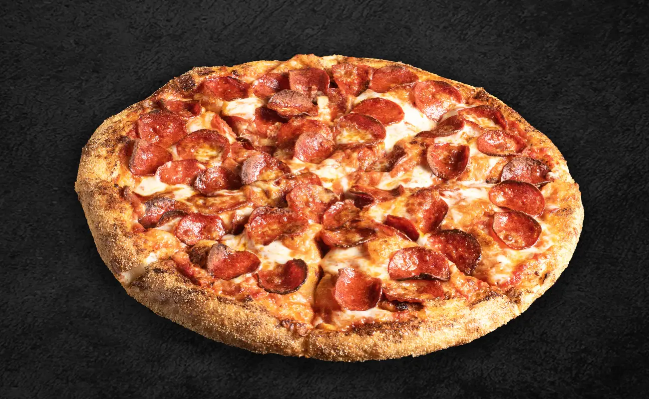 Classic pepperoni pizza with melted cheese and crispy pepperoni slices on a golden-brown crust, set against a dark textured background.