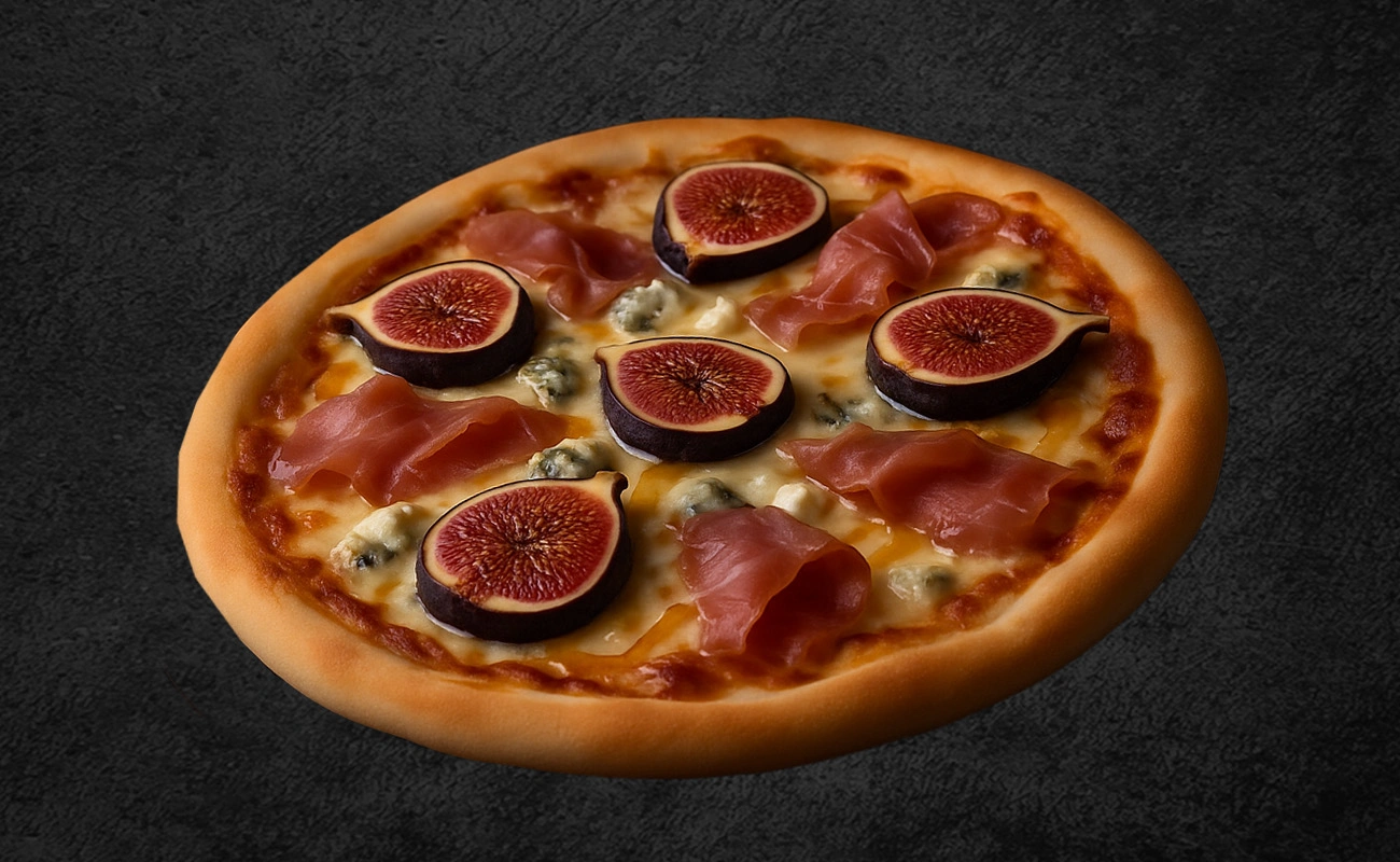 Gourmet pizza topped with fresh fig slices, prosciutto, blue cheese crumbles, and melted mozzarella on a dark background.
