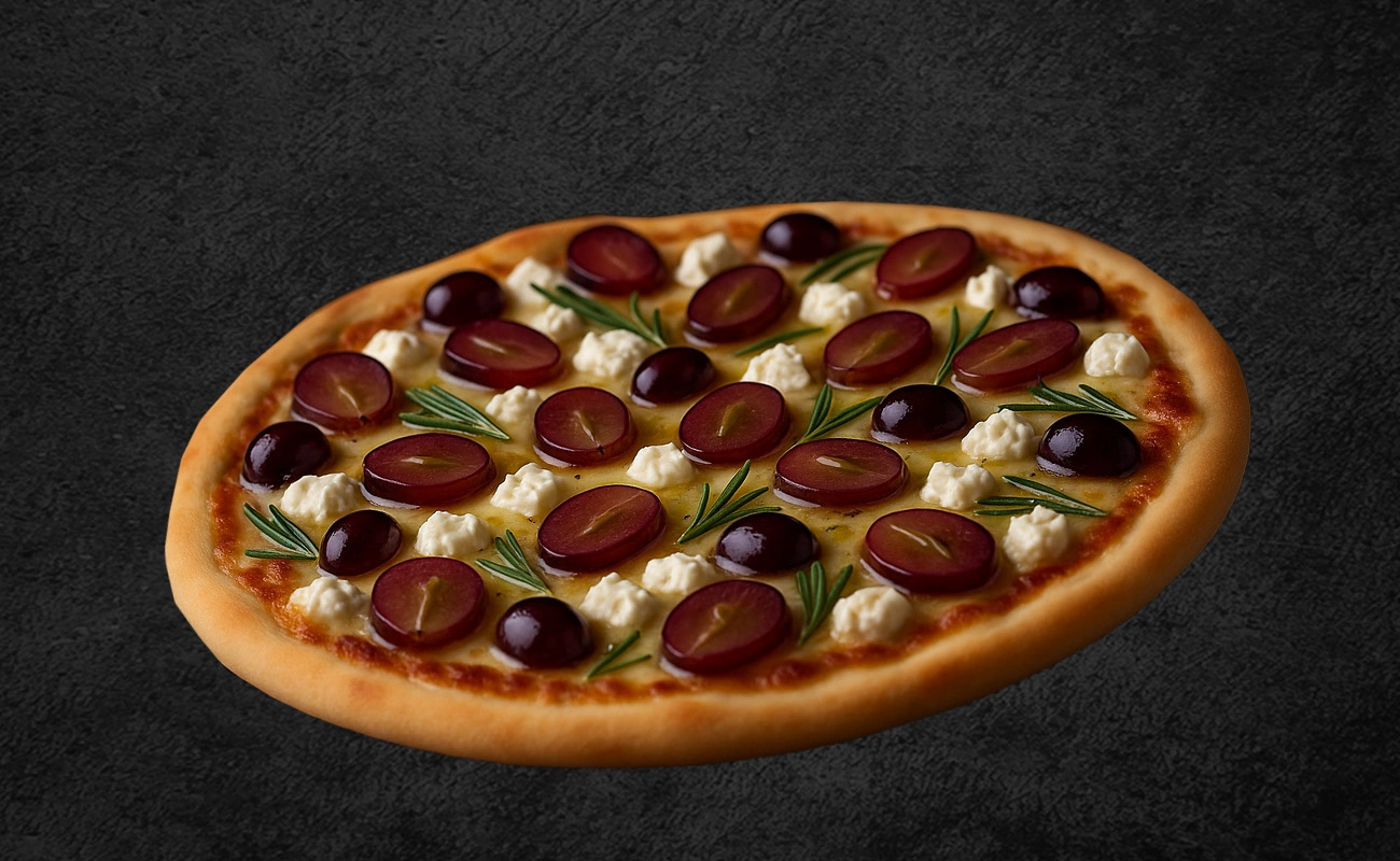 Artisan pizza topped with red grapes, ricotta cheese, and fresh rosemary sprigs on a dark background.