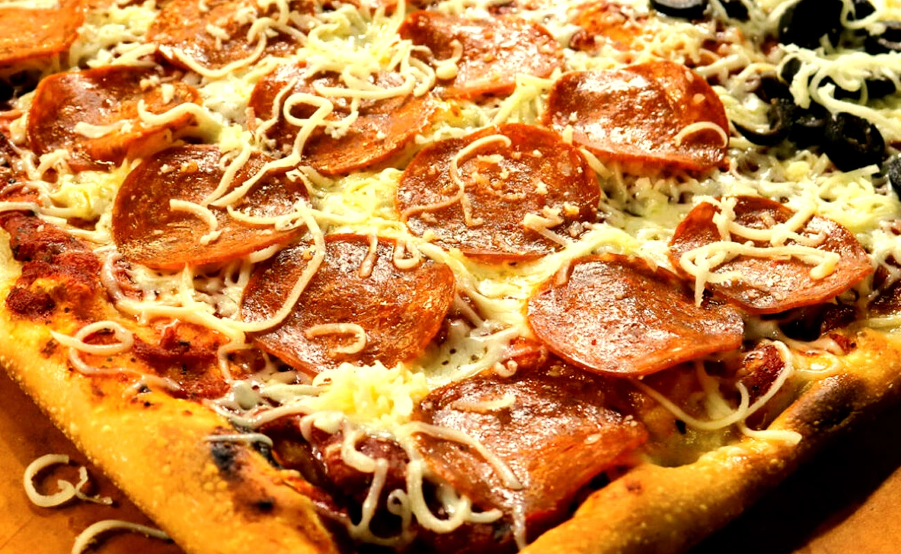 Ohio Valley-style pizza topped with pepperoni and freshly shredded cheese added after baking for a unique flavor.