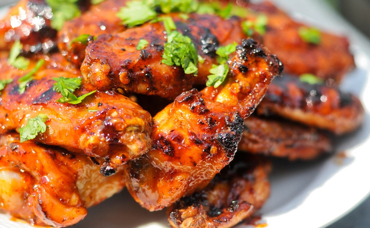 Golden, glossy chicken wings and honey dipper highlighting the sweet-spicy Chipotle Honey Mustard glaze.