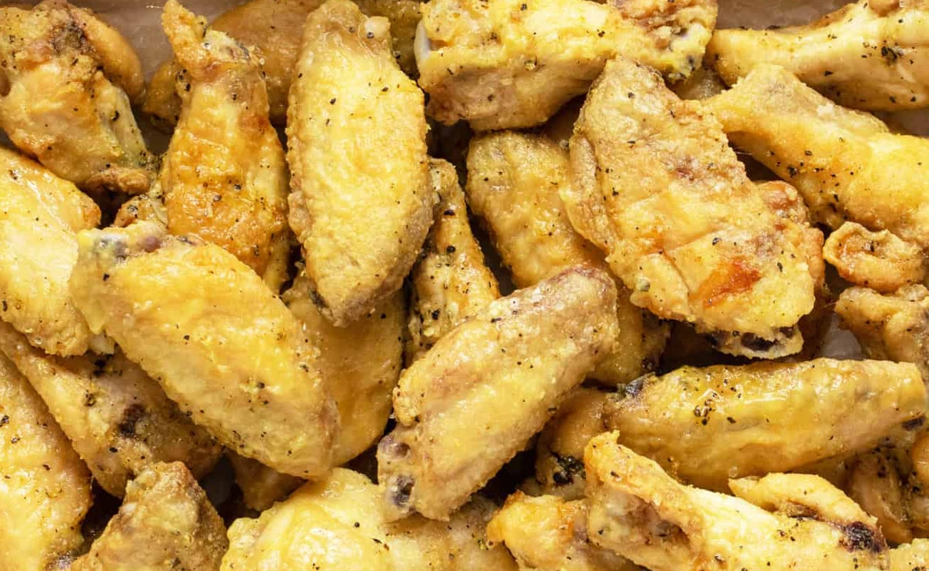 Lemon Pepper Classic crispy fried chicken wings seasoned with salt and pepper – golden brown dry rub wings
